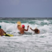 Three participants hit the waves