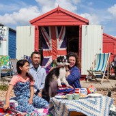 Behind Claire, and her partner Tok and 12-year-old daughter Hatti, a second-hand flag provides privacy for changing bathers