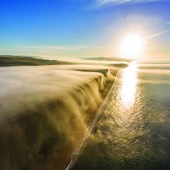 Coast Fog cascades from the cliff edge in West Bay, Dorset, UK. Photo: James Loveridge. jamesloveridgephotography.co.uk