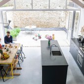 Misha fashioned the dining table and bench from some of the original floorboards and the couple made the concrete worktops themselves