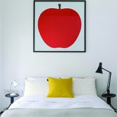 The apple print above the bed in the master bedroom was designed by Enzo Mari in 1963