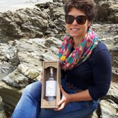 Nicola Smith proudly displays the bottle of gin that she produced