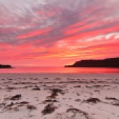 A spectacular sunset at Calgary Bay. Image: GFC Photography/Shutterstock
