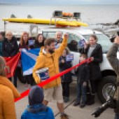 Triumphantly crossing the finishing line after 9,500 miles around the coast of Britain and Ireland