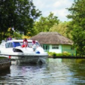 Visit Wroxham in Norfolk and take to the Norfolk Broads