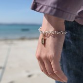 The boat charm was inspired by the keel shape of the Page family’s rowing boat