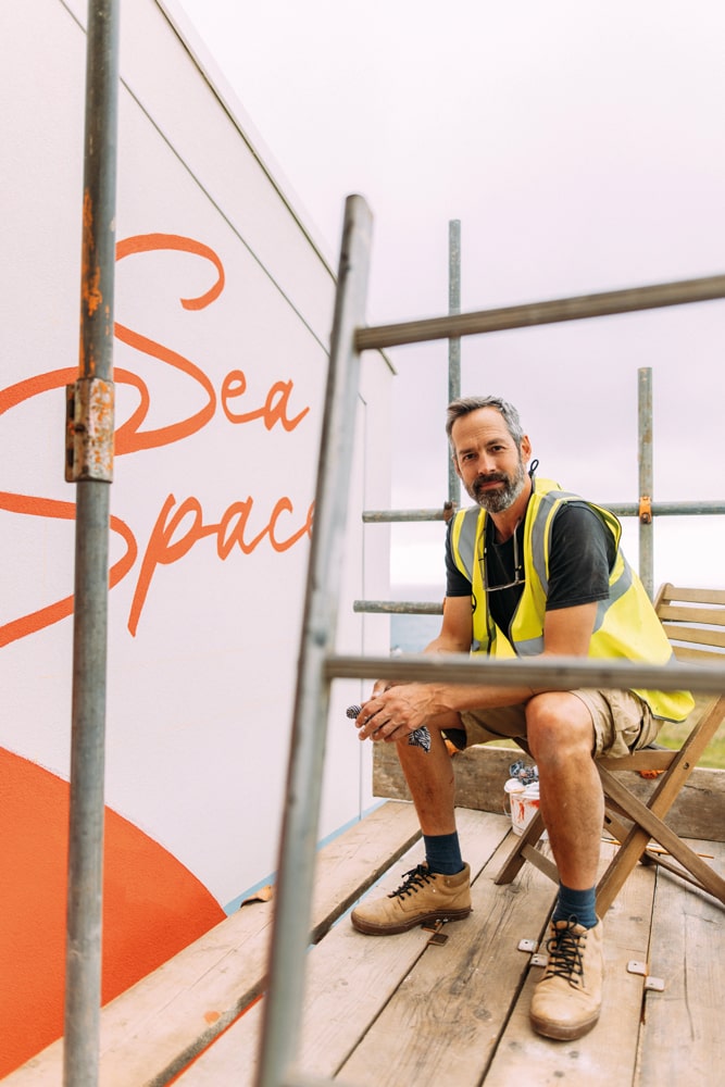 the bold and dynamic three-storey mural at SeaSpace took almost 100 hours to paint – Phil was selected for his artistic skills, and also as a champion of creativity within the local community - photo credit Adj Brown