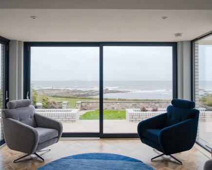 The windows are designed to frame the beauty of the coastline like a living picture. Photography Katie Pryde.