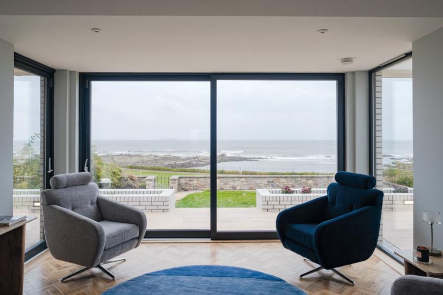 The windows are designed to frame the beauty of the coastline like a living picture. Photography Katie Pryde.