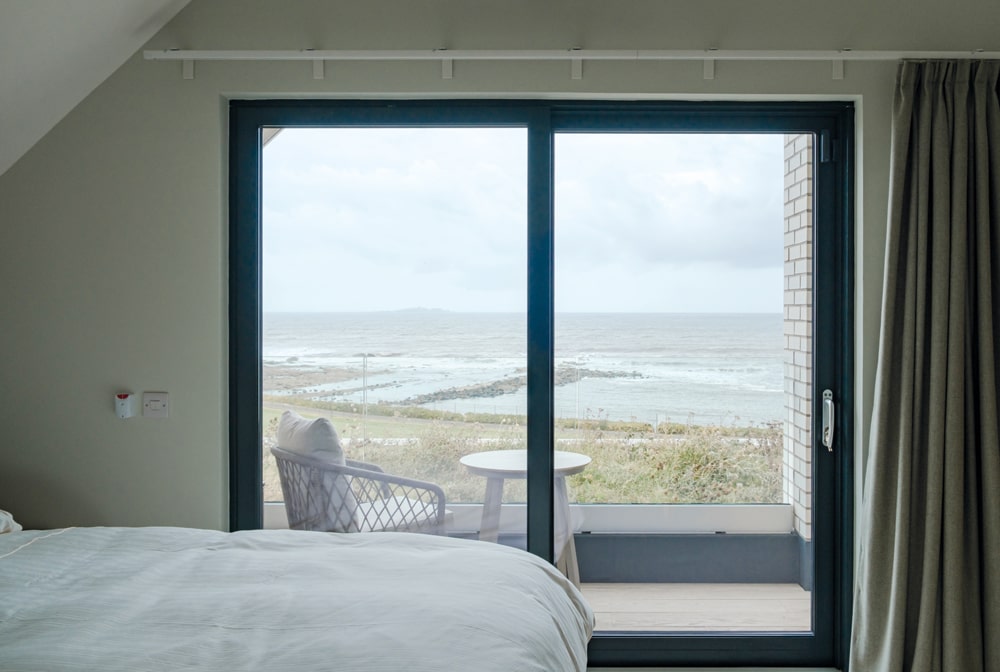 The indoor-outdoor integration is seamless too, with large windows, plus balconies and exterior areas which are designed to make the most of the view while offering shelter. Photography Katie Pryde.
