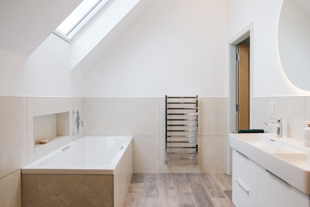 Minimal design, natural materials and neutral shades create a timeless look and a sense of calm in the bedrooms, bathrooms and hallways. Photography Katie Pryde.