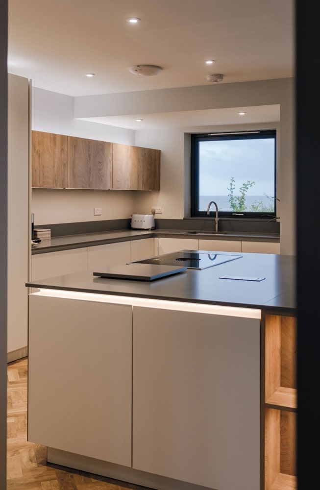 Inside the property, the palette is natural, and echoes the coastal colours outside. Photography Katie Pryde.