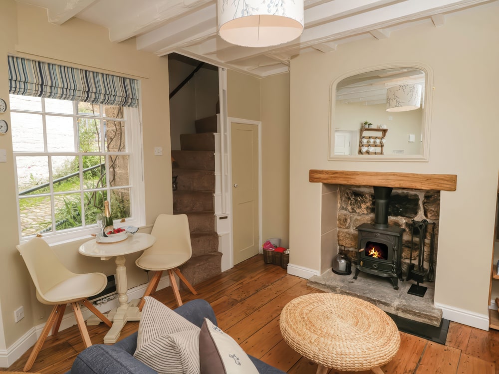 Warm up by the wood-burning stove after a windswept stroll - Oakridge Cottage