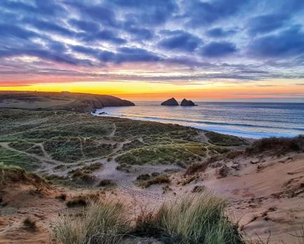 Popular with swimmers and surfers, Holywell Bay in Cornwall is home to St Cuthbert’s Cave – accessible during low tide - photo credit Sally Lewis