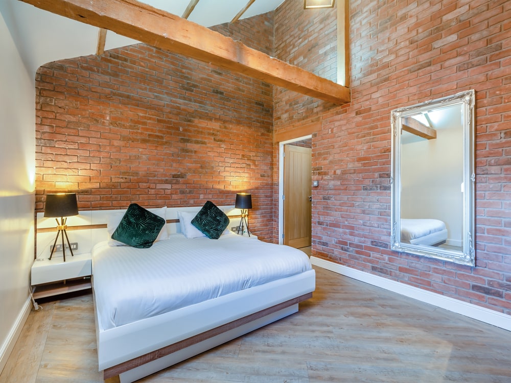 A double bedroom in the barn, which 
has been sympathetically converted, combining luxury fittings with exposed beams - The Barnacle Goose