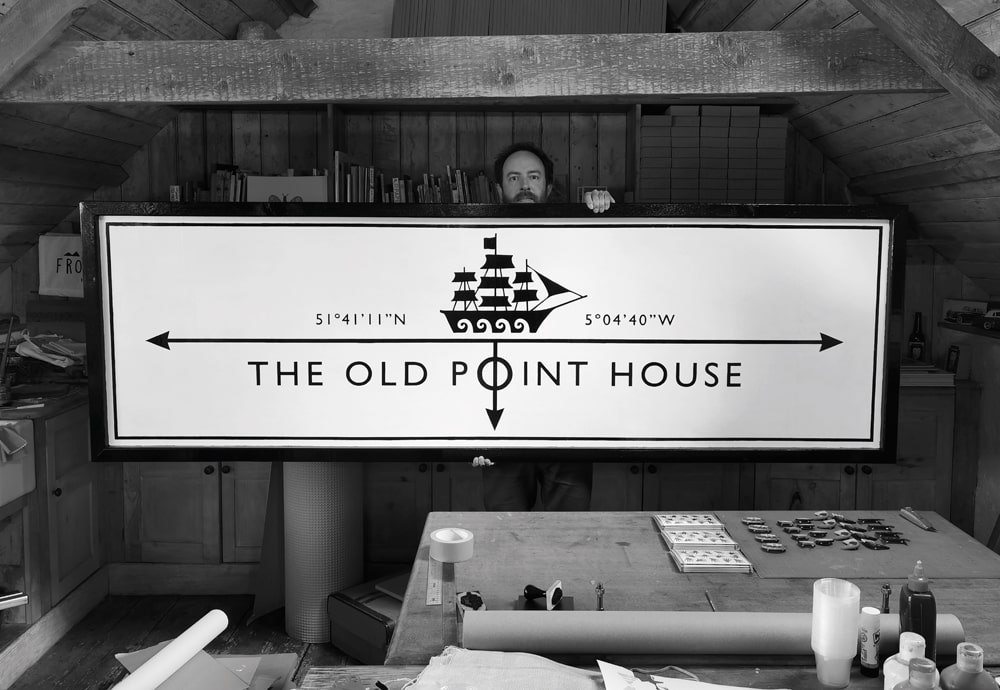 The artist with the striking sign he designed for The Old Point House coastal pub and restaurant in Angle