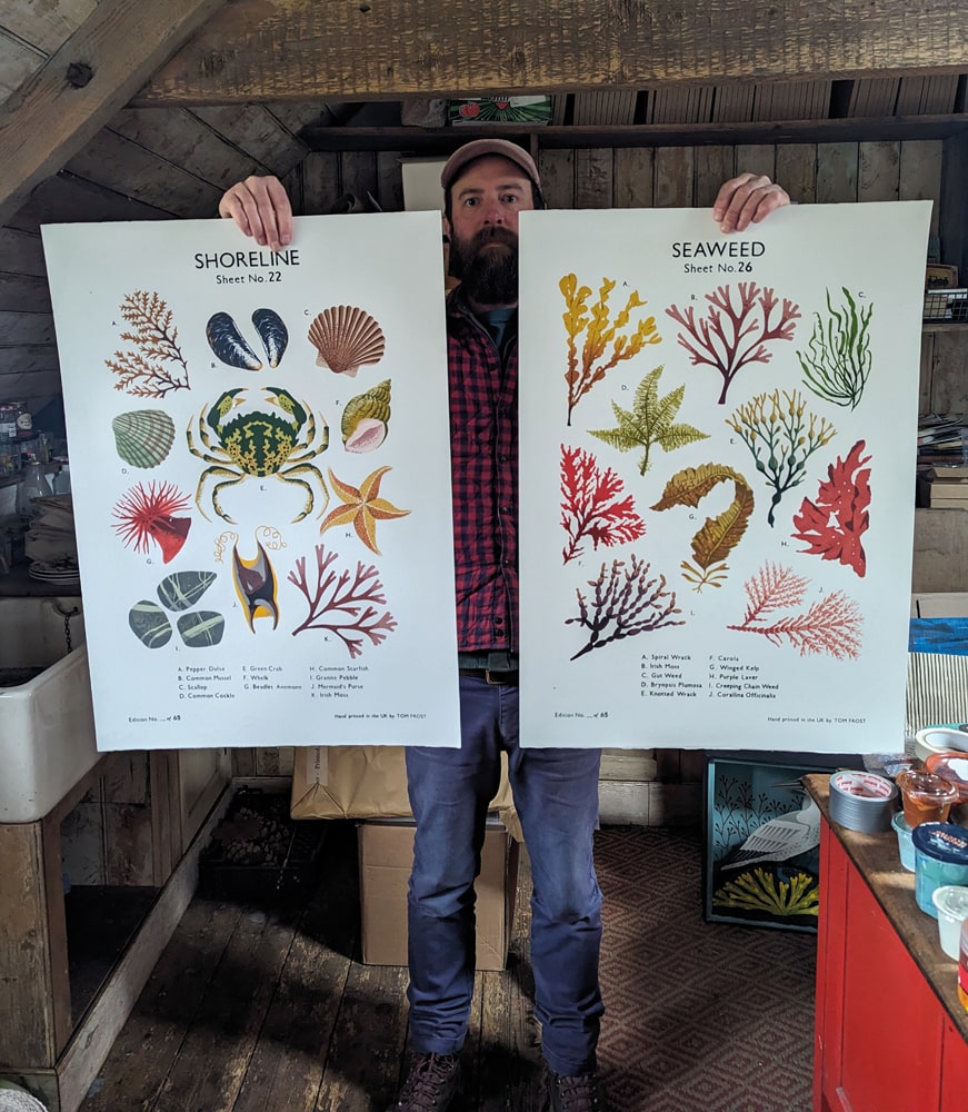 Tom with two of his ‘old-style’ School Chart prints, the marine-inspired Shoreline and Seaweed