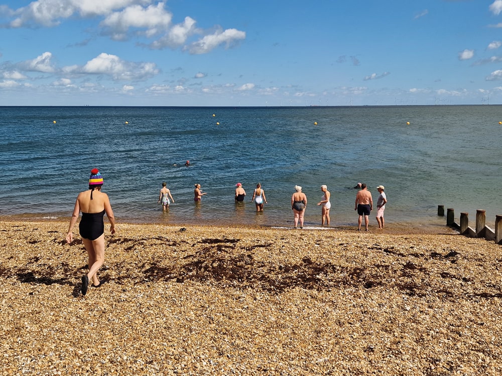 Members of the Bluetits head into the sea at Whitstable