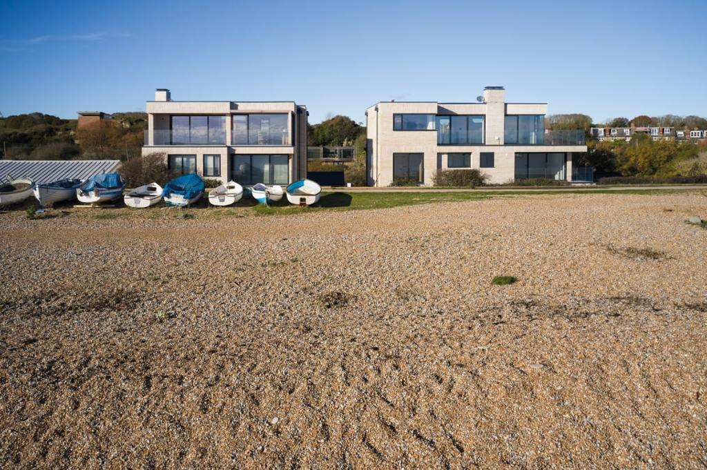 The houses overlook the shingle beach