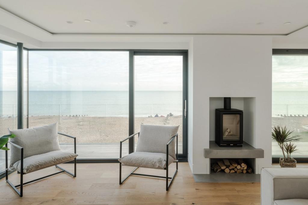 Balcony access and a wood-burning stove help to create the ideal space for year-round coastal living