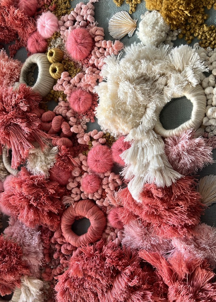 Close-ups of two works showcase their intricate details