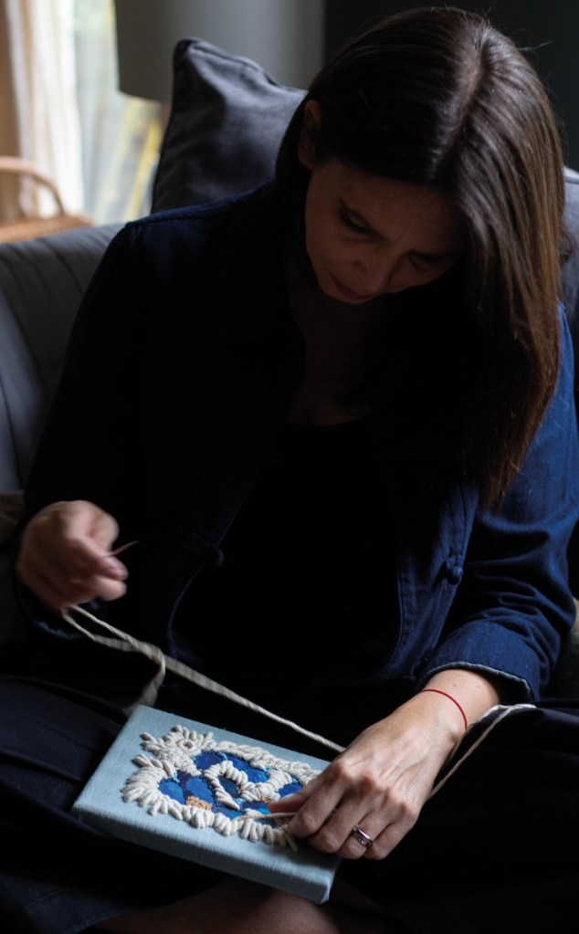 Hand-stitching an intricate embroidered outline