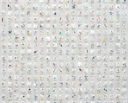 Steve creates a three-dimensional sculpture, with monochrome wall art in the background; this work features tiny fragments of marine plastic and filaments embedded in squares of plaster