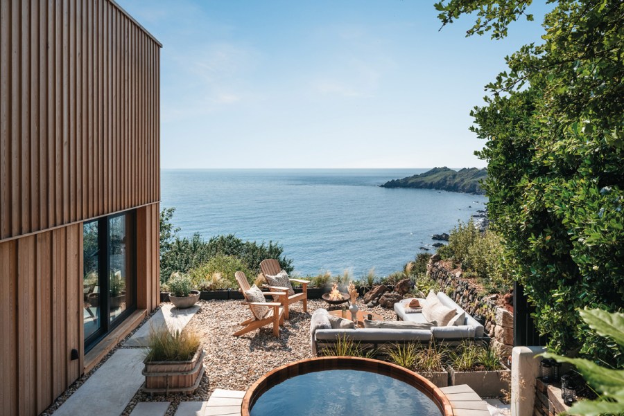 The outdoor area boasts a cedar spa tub and panoramic sea views