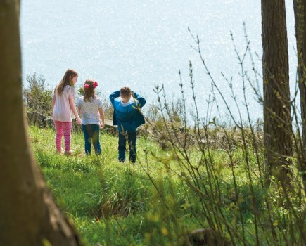 Children looking out to sea from the grounds of Coleton Fishacre, South Devon. Photography National Trust Scotland, ©National Trust Images/Trevor Ray Hart